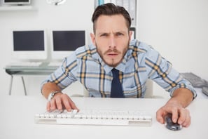 Focused casual businessman working at his desk in his office-1
